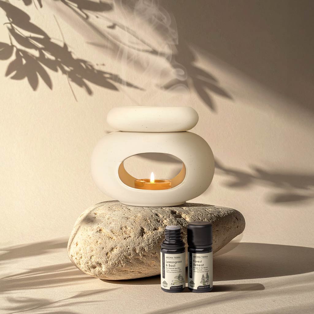 Aroma Tierra Lona ceramic candle burner on natural stone with Lemongrass &amp; Basil and Forest Retreat essential oils