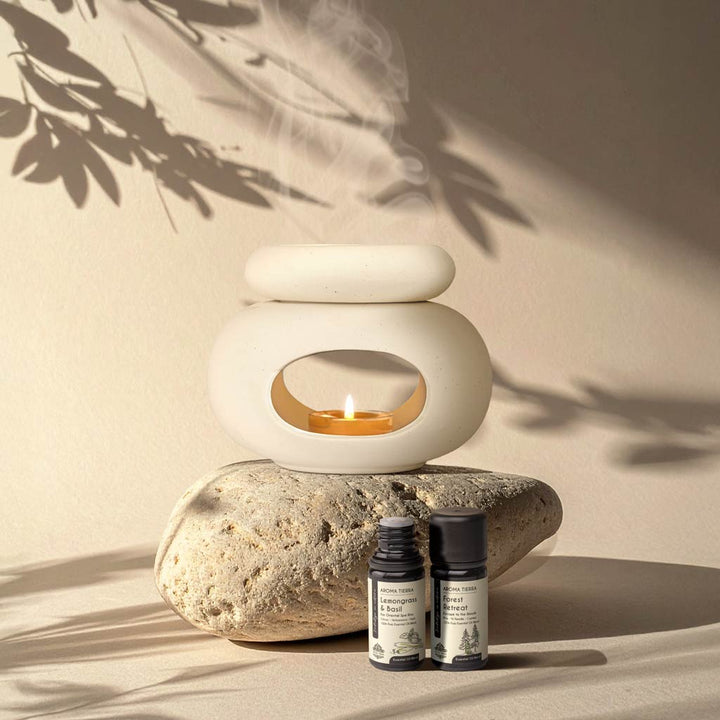 Aroma Tierra Lona ceramic candle burner on natural stone with Lemongrass &amp; Basil and Forest Retreat essential oils