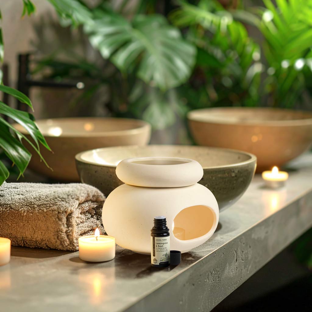 Aroma Tierra Lona ceramic candle burner diffuser in spa setting with Lemongrass &amp; Basil essential oil and candles
