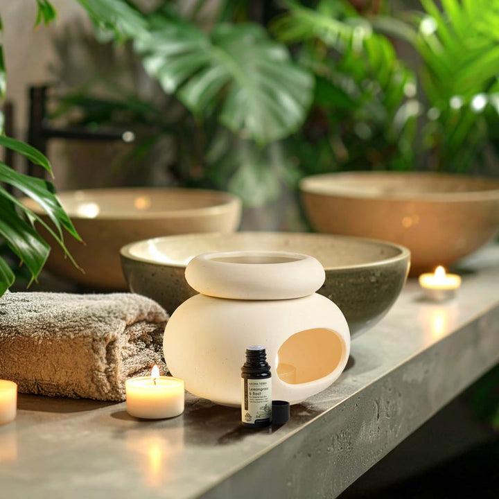 Aroma Tierra Lona ceramic candle burner diffuser in spa setting with Lemongrass &amp; Basil essential oil and candles