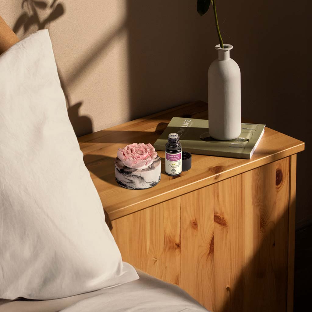 cera flora pink flower ceramic diffuser with lavender essential oil on bedside table