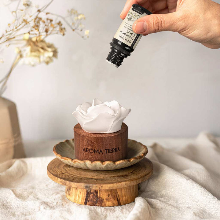 hand adding lemongrass &amp; basil essential oil to cera flora wood diffuser