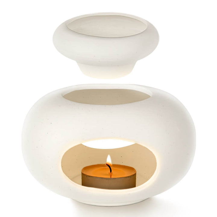 Aroma Tierra Lona ceramic candle burner showing separated oil dish and base with lit tea-light