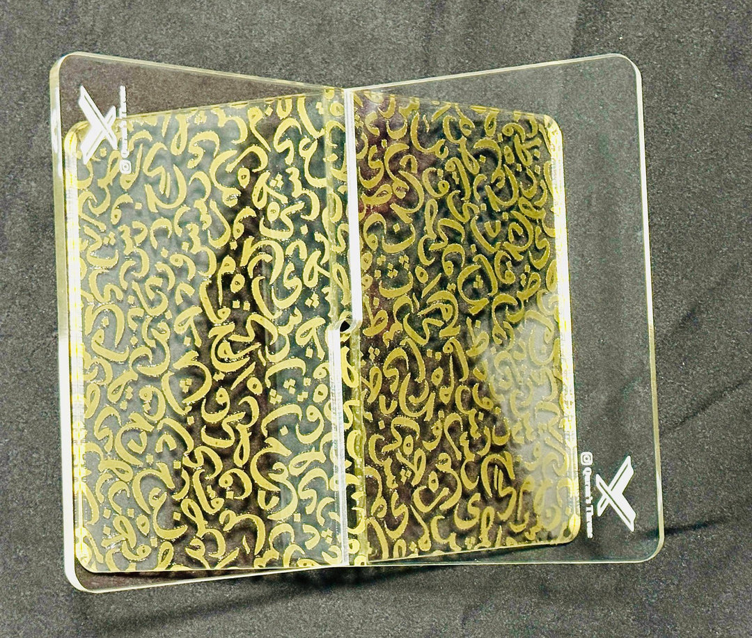 Transparent Quran stand made from 8mm acrylic with golden screen-printed Arabic design. Elegant, durable, and ideal for home, mosque, and gifts.