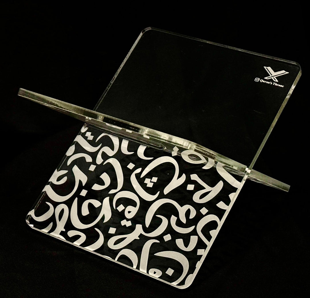 The Acrylic Quran Stand (Rehal) – Model INR is a refined and elegant Quran holder designed for durability and timeless Islamic aesthetics. Made from 8mm high-quality transparent acrylic, this Rehal features CNC-engraved Arabic alphabets, giving it a clean, premium, and long-lasting engraved finish.

Its two interlocking acrylic plates allow for easy assembly, strong support, and convenient storage. The engraved Arabic alphabet design adds a subtle yet sophisticated Islamic touch, making it ideal for daily Q