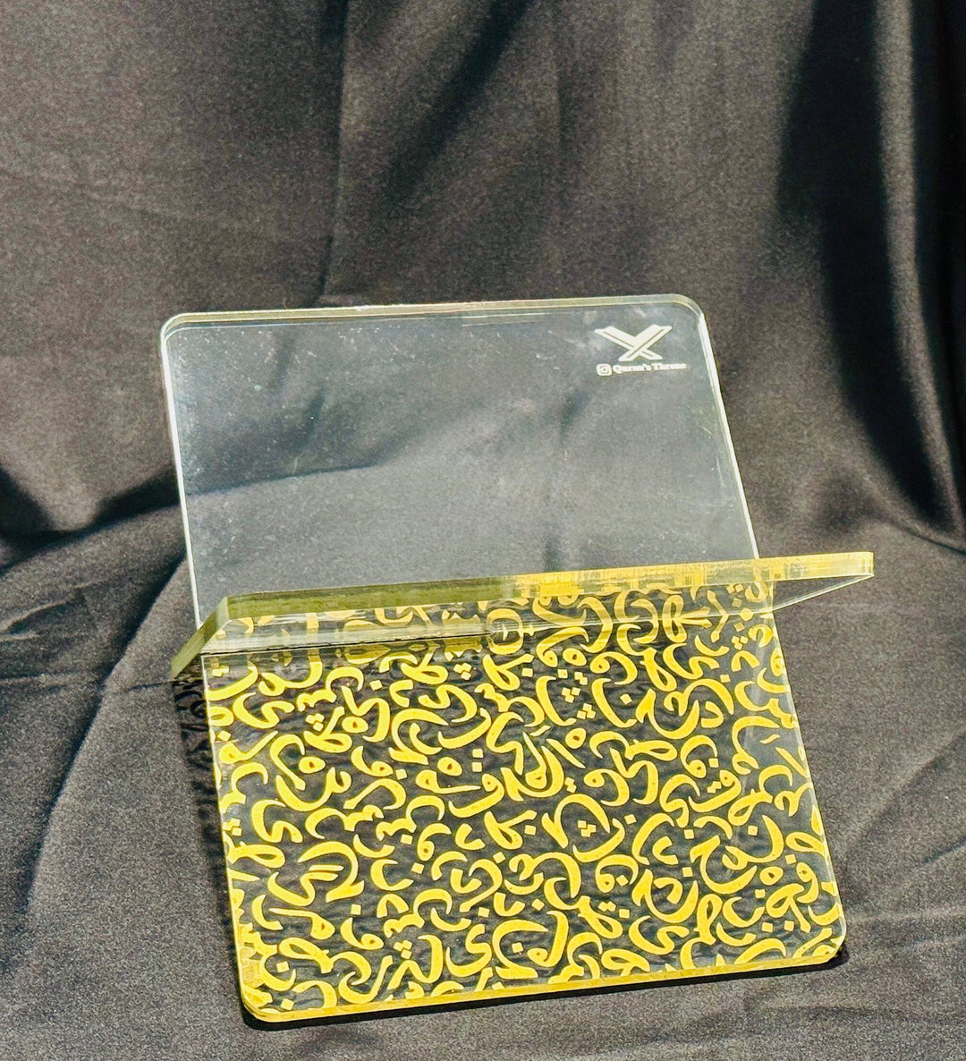 Transparent Quran stand made from 8mm acrylic with golden screen-printed Arabic design. Elegant, durable, and ideal for home, mosque, and gifts.