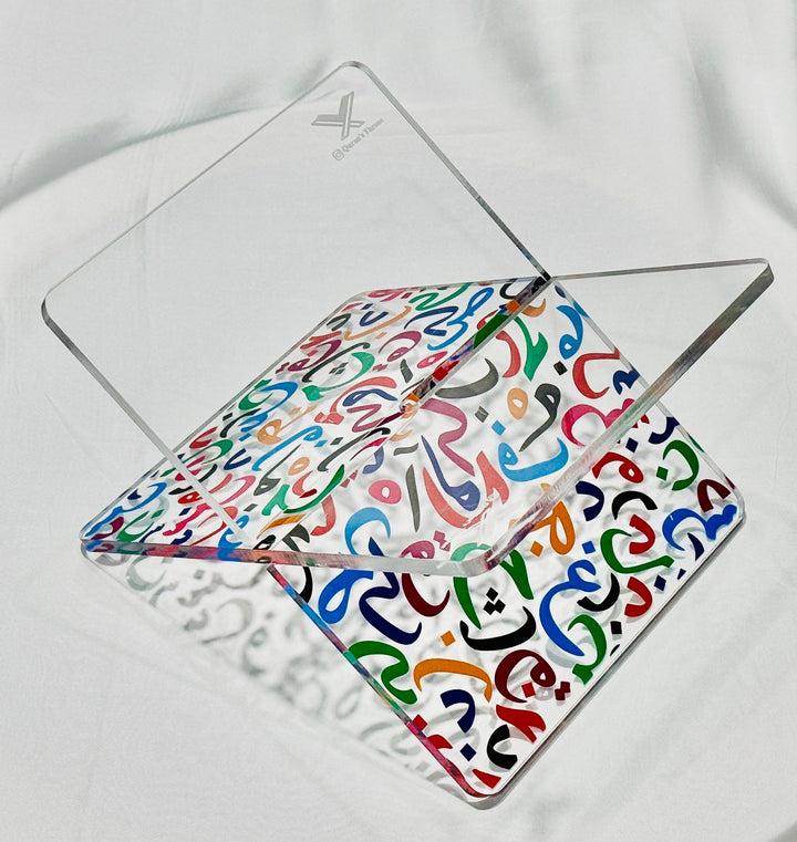 Elegant acrylic Quran stand made from 8mm acrylic with UV printed multi-color Arabic alphabets. Durable, stylish, and ideal for home, mosque, and gifting.