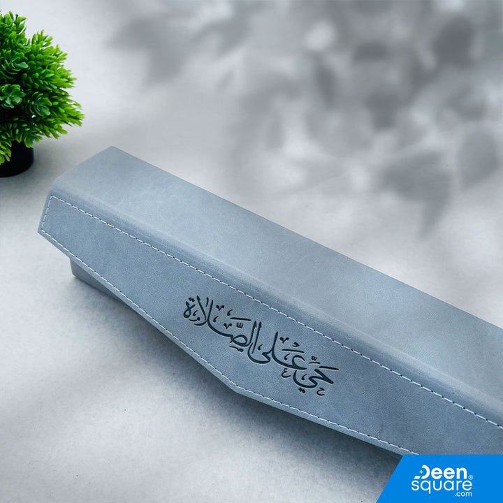 Portable pocket prayer mat with elegant PU leather case. Lightweight, compact, and ideal for travel, office, and daily prayer. Available in brown and grey.