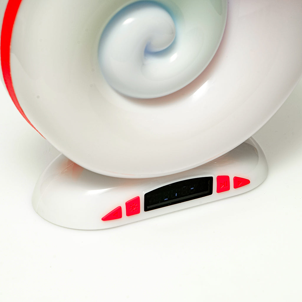 Buy Sea Snail table lamp with Bluetooth speaker &amp; clock at deensquare.com Dubai UAE. Stylish rechargeable lamp with immersive sound modes.