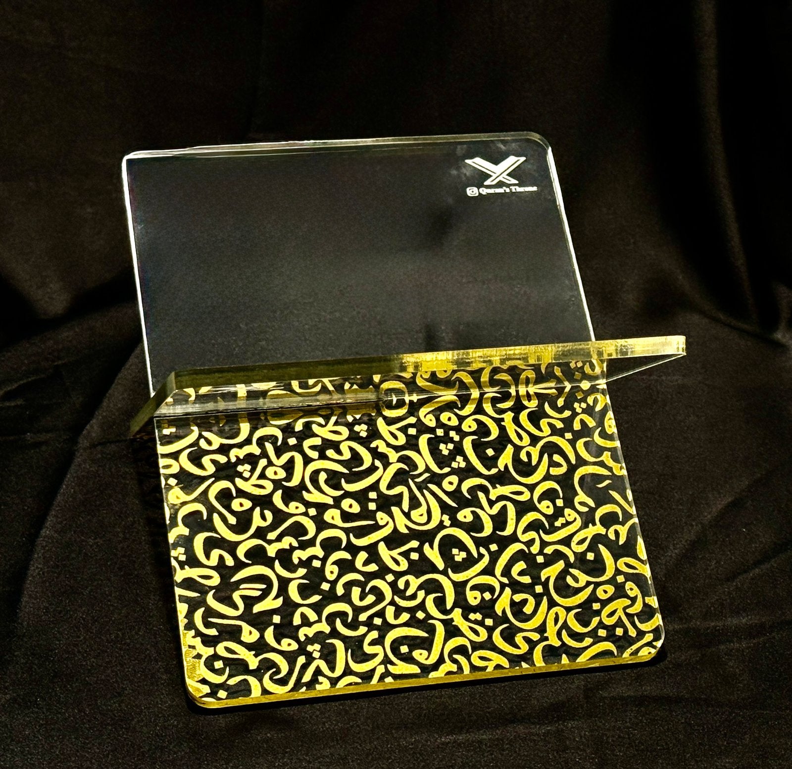 Transparent Quran stand made from 8mm acrylic with golden screen-printed Arabic design. Elegant, durable, and ideal for home, mosque, and gifts.